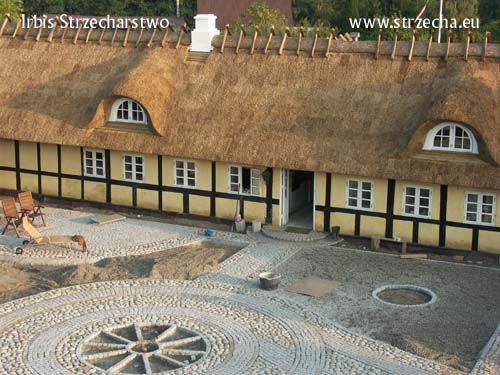 Reed roof - a building after renovation together with a courtyard