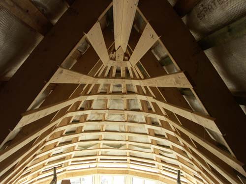 A built-in winter garden covered with thatched roofs, preparation for covering with gypsum boards, after laying mineral wool insulation