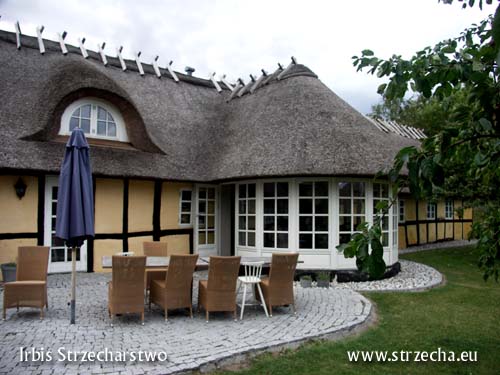 Thatched roof - a building after renovation with a courtyard from the garden side - made by Irbis Thatching