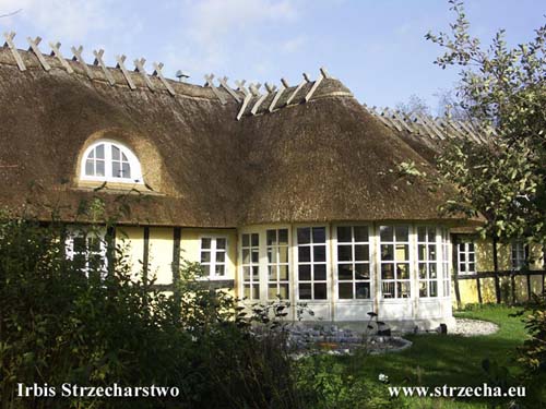 Reed roof - extension of the winter garden to the façade of a thatched building with wooden roof construction