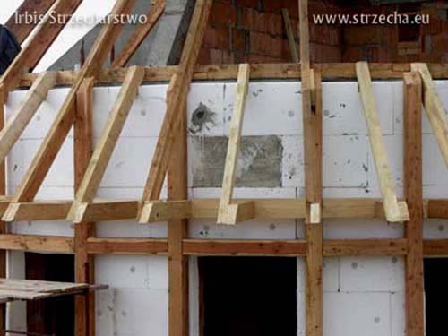 Thatched roof: wooden structure of the roof eaves on the semi-circular building and insulation of the facade